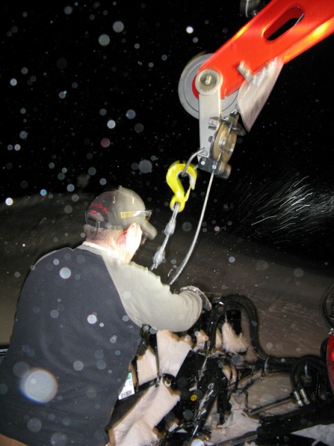 Curtis Bender retrieves the cable from the Pisten Bully winch cat